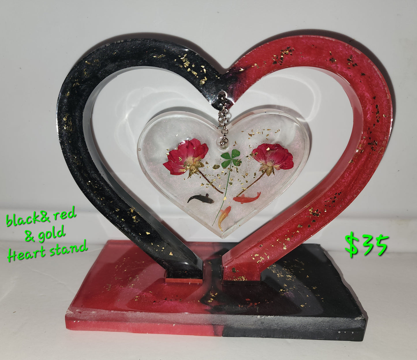 Red,black with sprinkles of gold Heart theme stand. With dried roses and fish in side. All made from epoxy