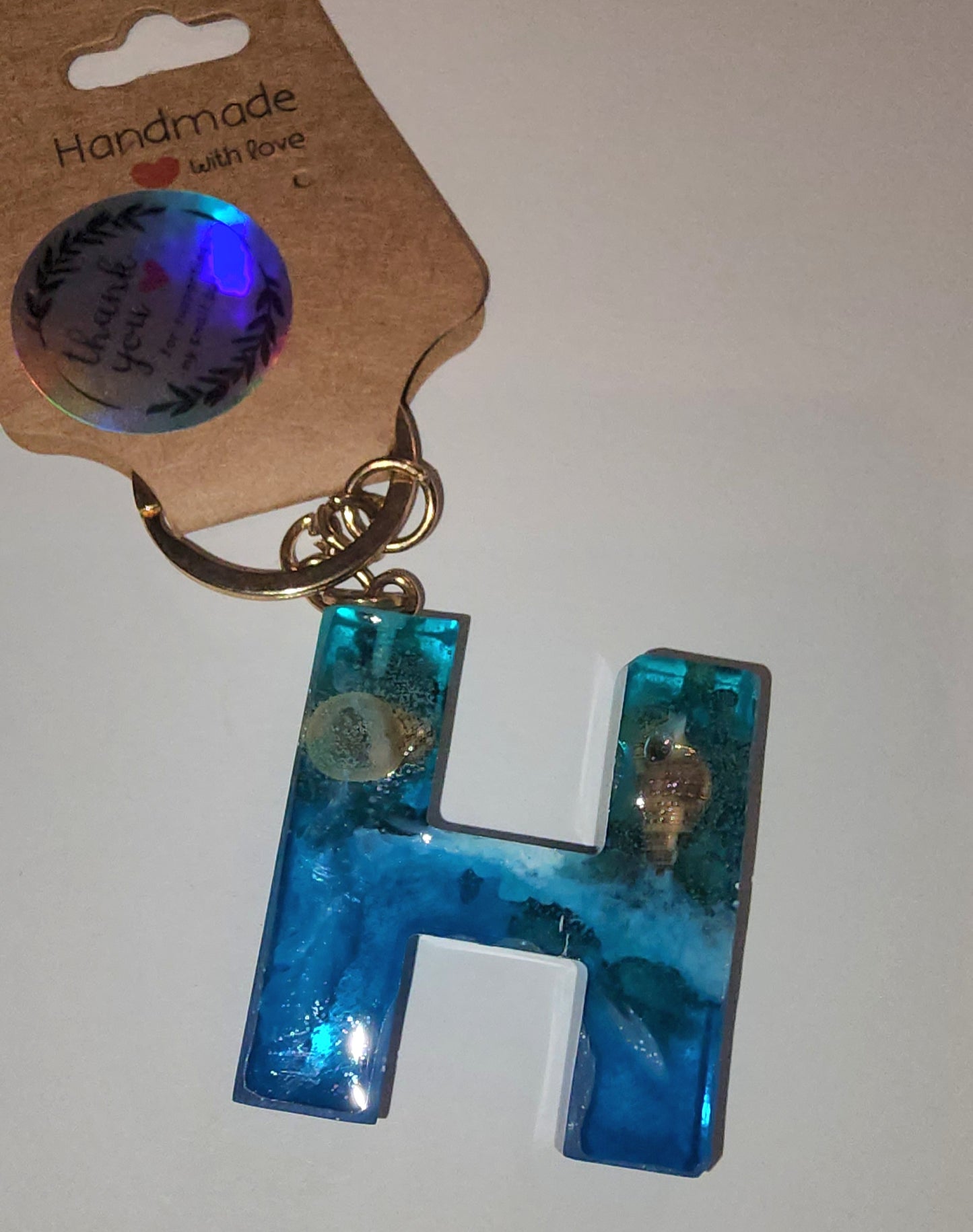 Epoxy alphabet keychains in various styles. I have  beach themes and mermaid colors. I have a few with rose pedals and gold flakes. All handmade by me and Locally handcrafted.