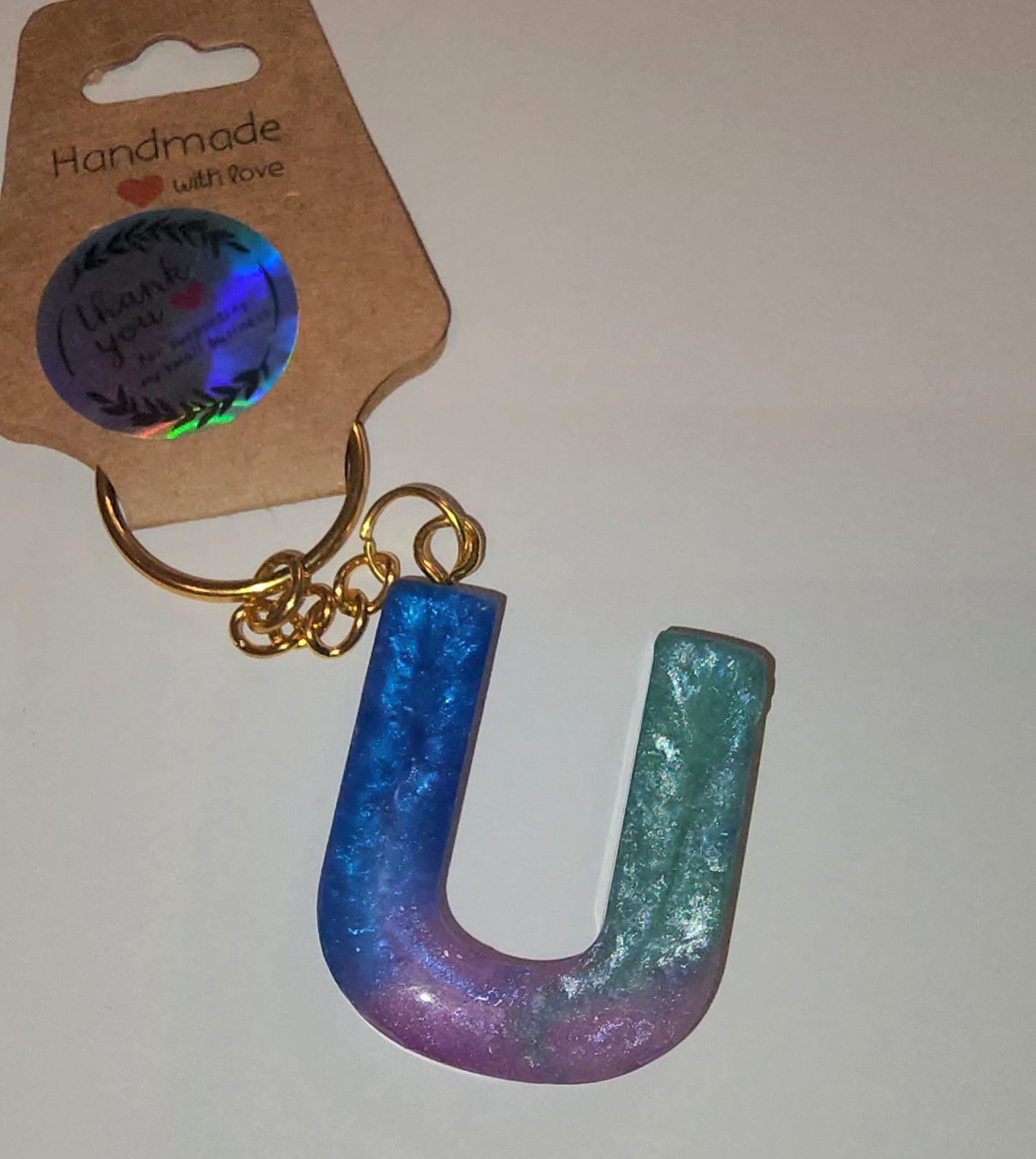 Epoxy alphabet keychains in various styles. I have  beach themes and mermaid colors. I have a few with rose pedals and gold flakes. All handmade by me and Locally handcrafted.