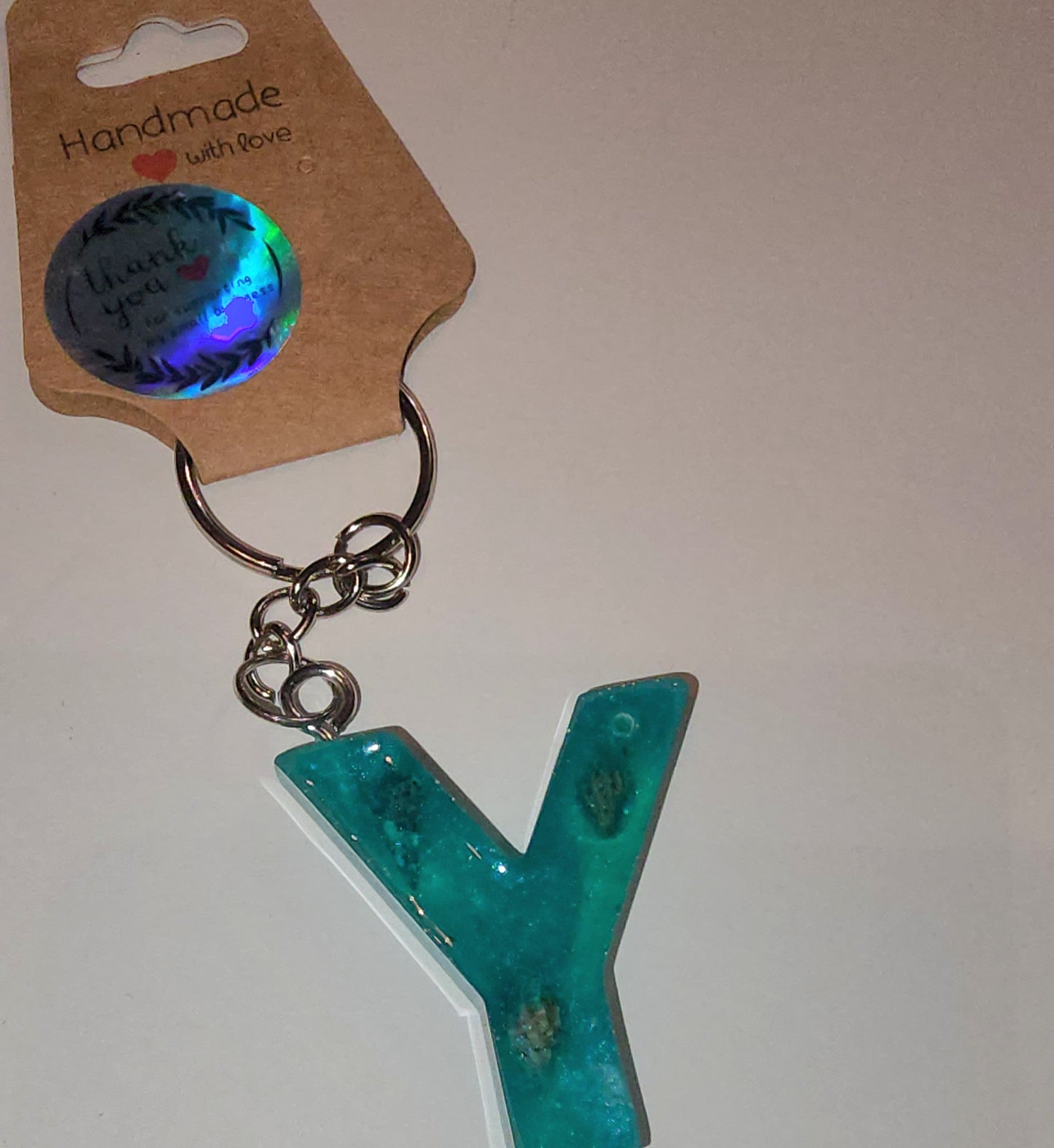 Epoxy alphabet keychains in various styles. I have  beach themes and mermaid colors. I have a few with rose pedals and gold flakes. All handmade by me and Locally handcrafted.