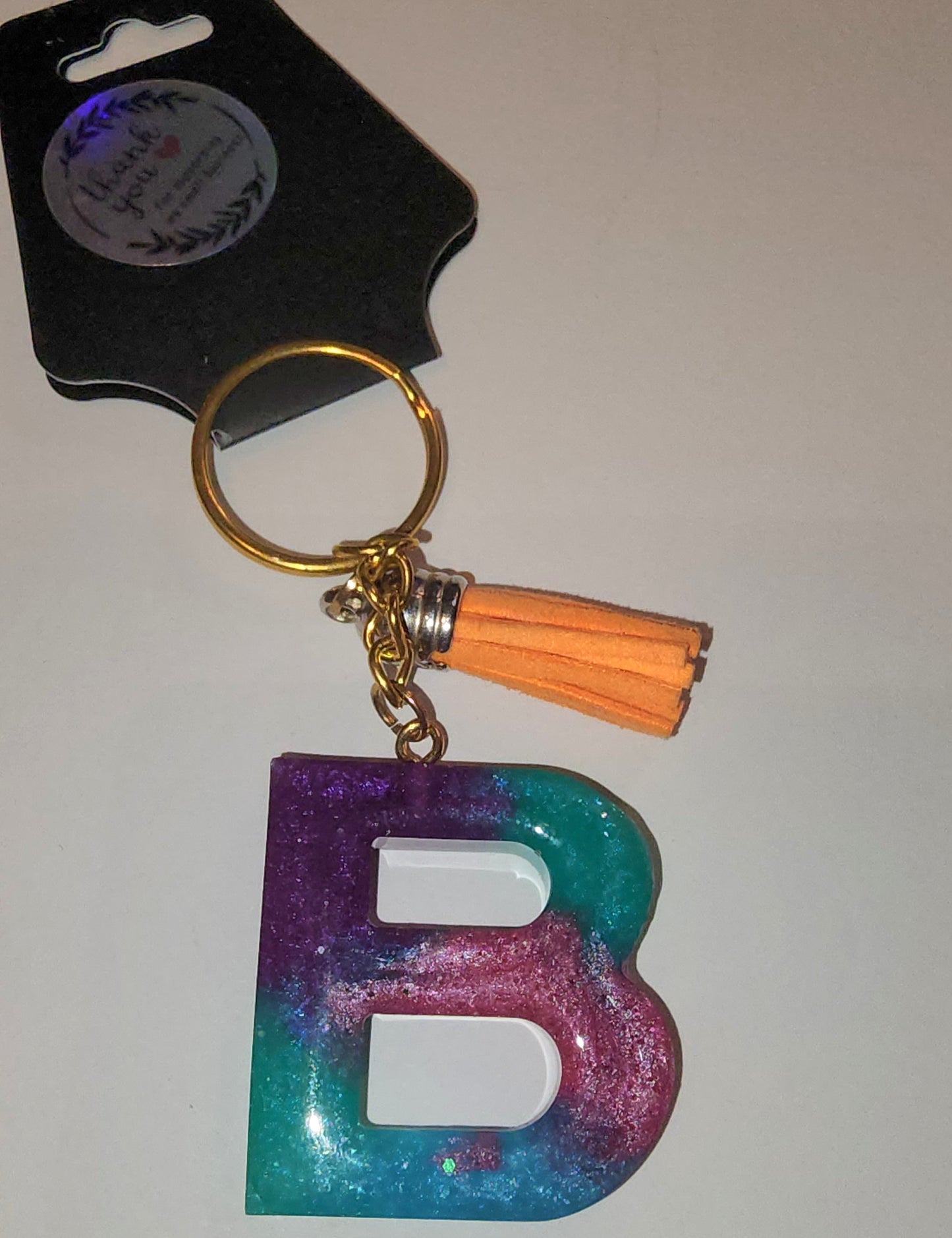 Epoxy alphabet keychains in various styles. I have  beach themes and mermaid colors. I have a few with rose pedals and gold flakes. All handmade by me and Locally handcrafted.