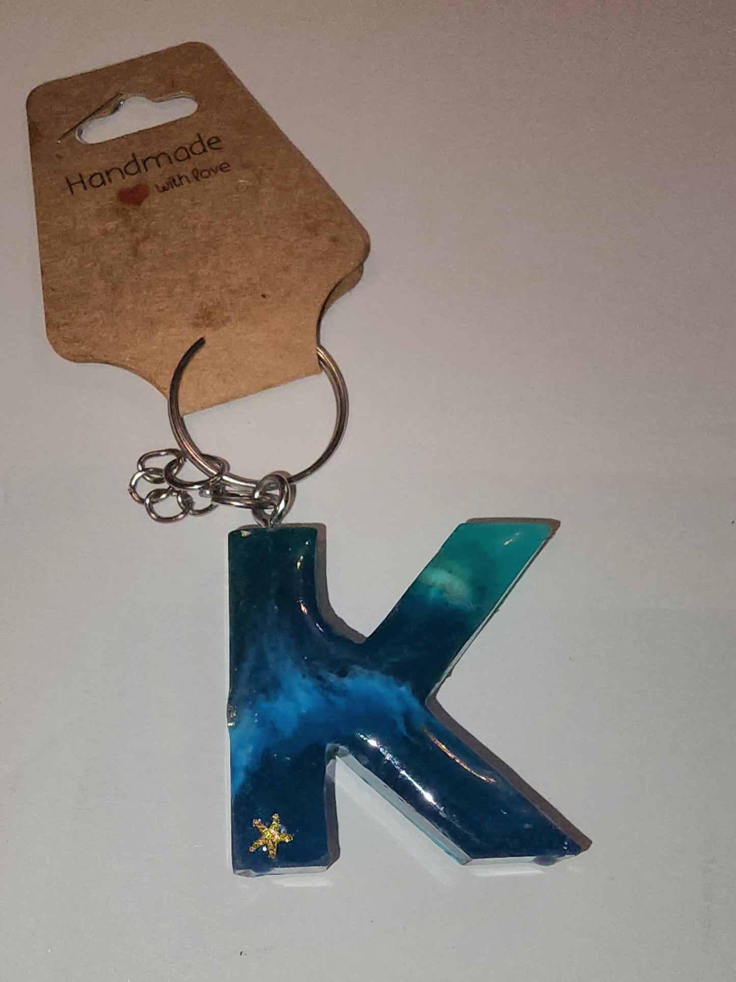 Epoxy alphabet keychains in various styles. I have  beach themes and mermaid colors. I have a few with rose pedals and gold flakes. All handmade by me and Locally handcrafted.