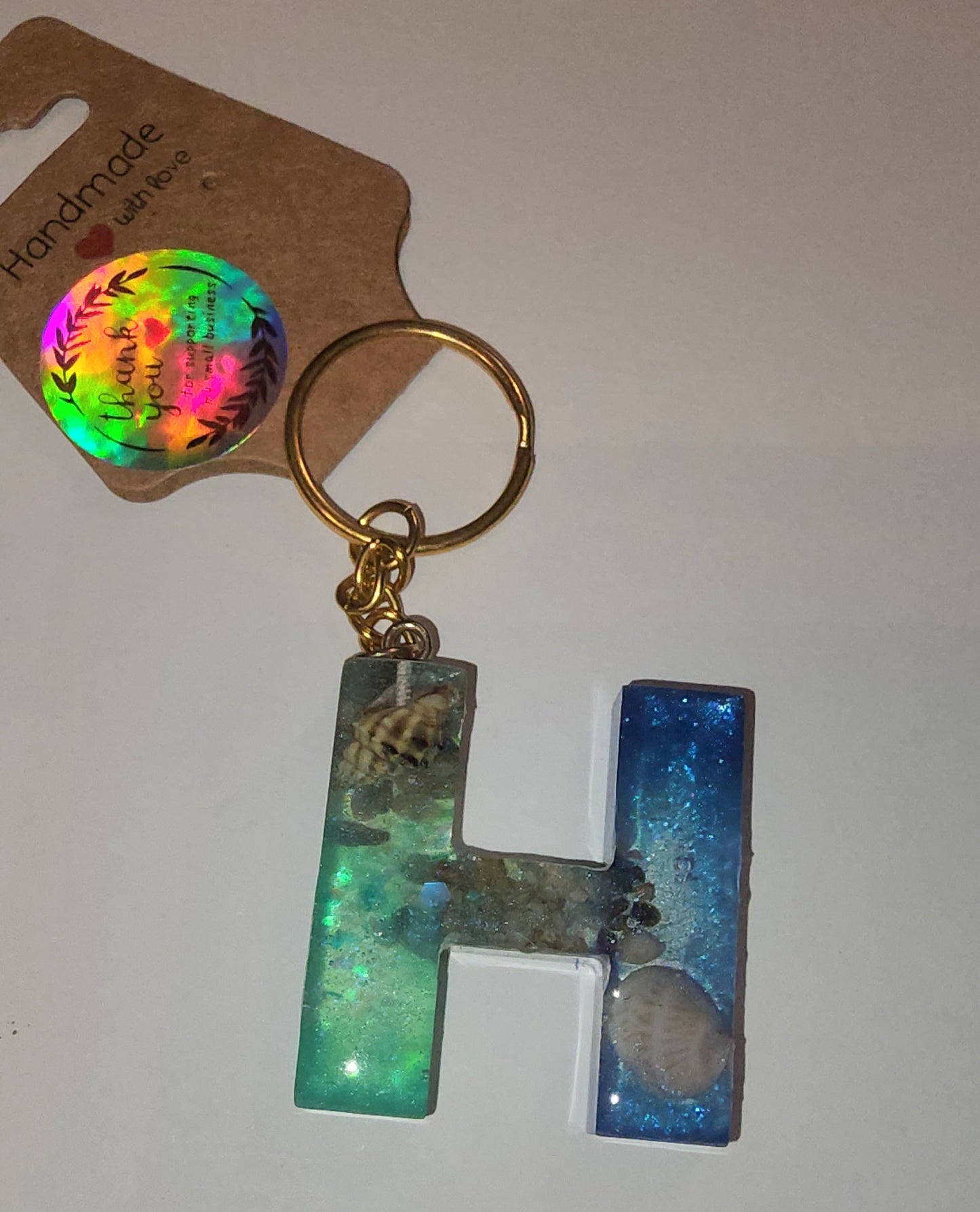 Epoxy alphabet keychains in various styles. I have  beach themes and mermaid colors. I have a few with rose pedals and gold flakes. All handmade by me and Locally handcrafted.