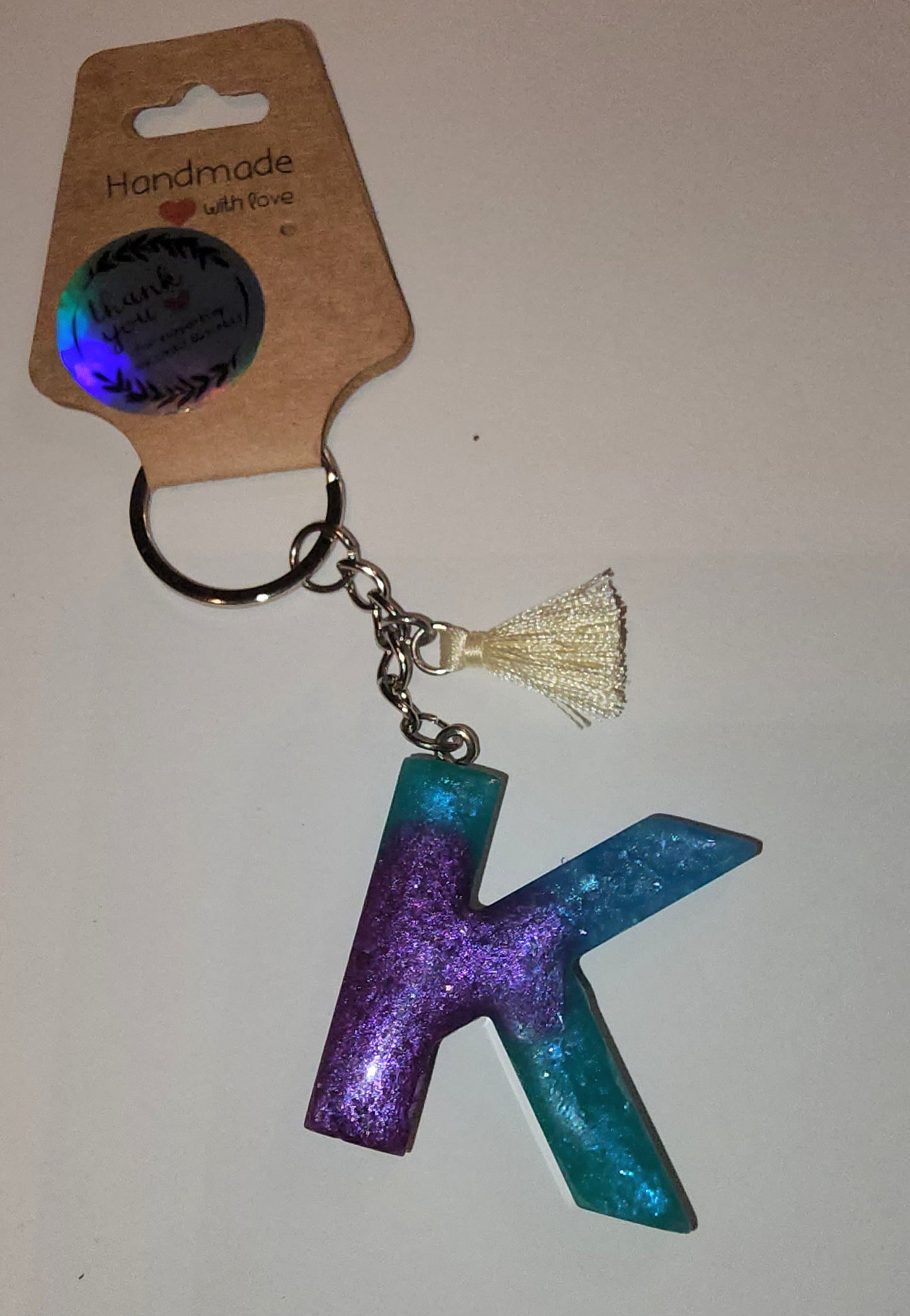 Epoxy alphabet keychains in various styles. I have  beach themes and mermaid colors. I have a few with rose pedals and gold flakes. All handmade by me and Locally handcrafted.