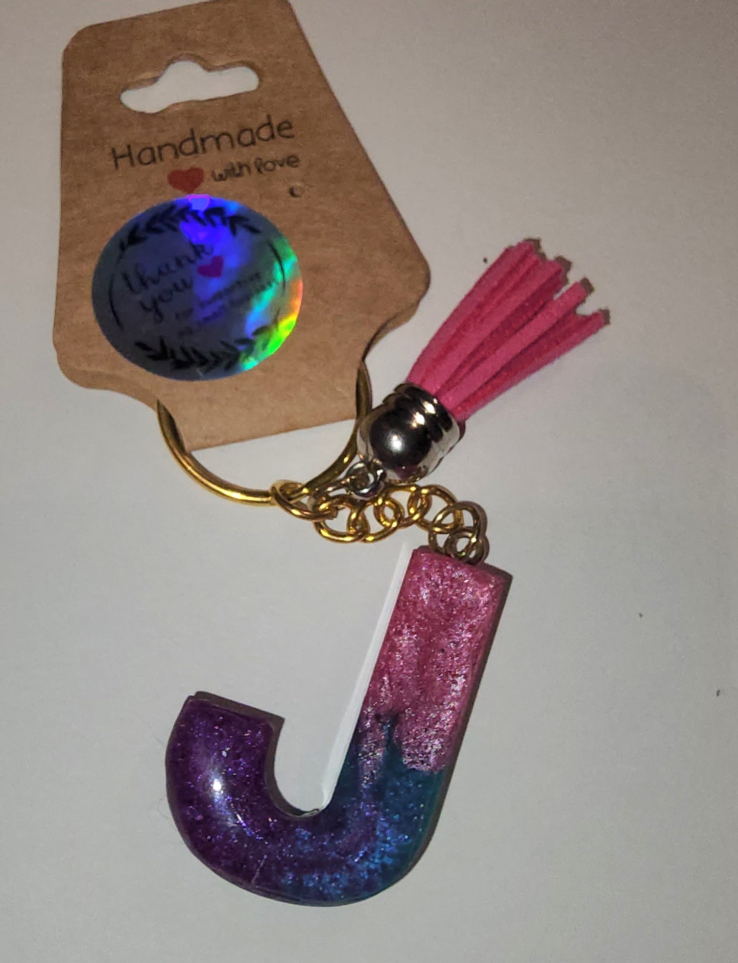 Epoxy alphabet keychains in various styles. I have  beach themes and mermaid colors. I have a few with rose pedals and gold flakes. All handmade by me and Locally handcrafted.