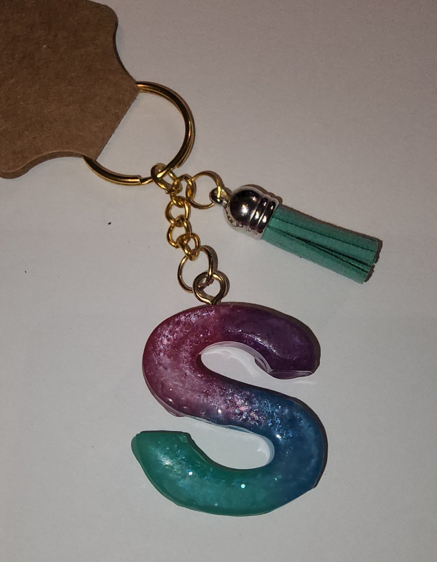 Epoxy alphabet keychains in various styles. I have  beach themes and mermaid colors. I have a few with rose pedals and gold flakes. All handmade by me and Locally handcrafted.