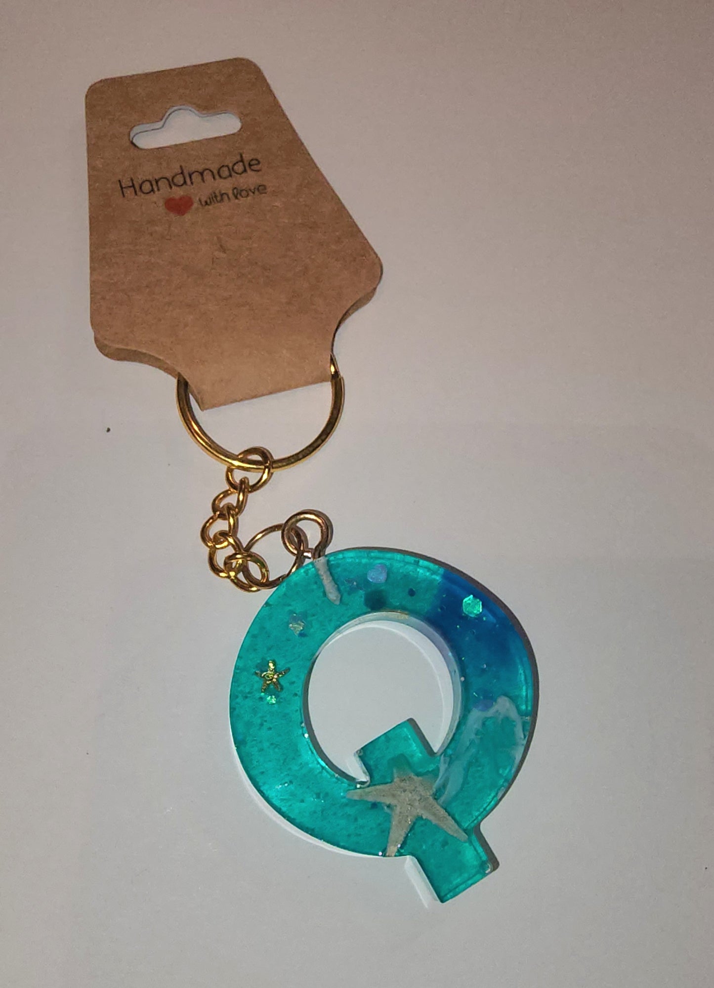 Epoxy alphabet keychains in various styles. I have  beach themes and mermaid colors. I have a few with rose pedals and gold flakes. All handmade by me and Locally handcrafted.