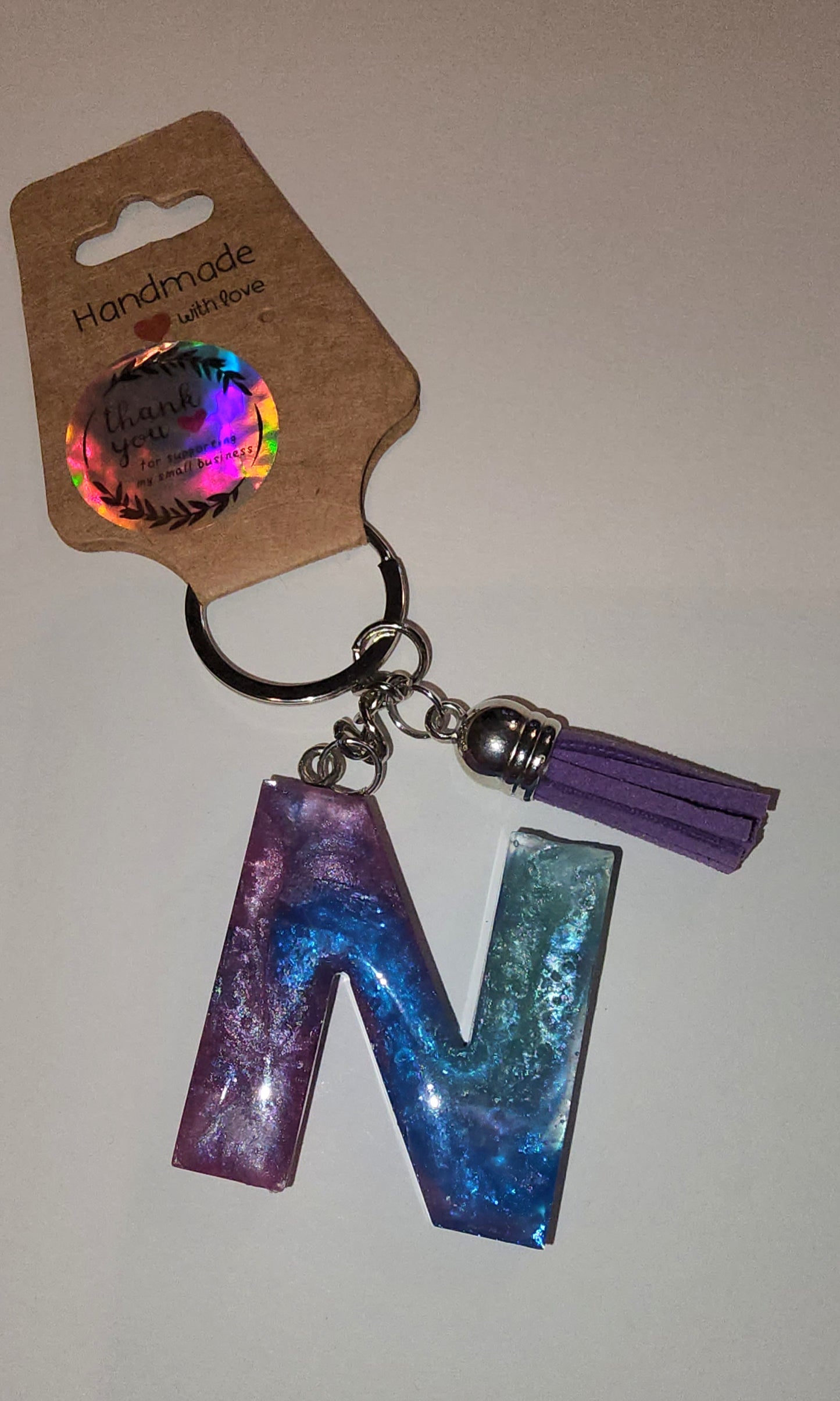 Epoxy alphabet keychains in various styles. I have  beach themes and mermaid colors. I have a few with rose pedals and gold flakes. All handmade by me and Locally handcrafted.